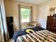 Comfortable bedroom with a large window for natural light and a cozy chair at 3321 Sycamore Dr, Columbus, IN 47203