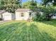 Single-story home shows a grass lawn, an adjacent garage, and mature landscaping at 3321 Sycamore Dr, Columbus, IN 47203