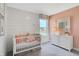 Bright bedroom with a crib, a dresser, and a large window at 3786 Cantebury Dr, Franklin, IN 46131