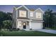 Charming two-story home with a well-manicured lawn, gray siding, white trim, and a two-car garage at 3786 Cantebury Dr, Franklin, IN 46131