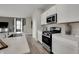 Stylish kitchen featuring stainless steel appliances, modern white cabinets, and functional island with sink at 3794 Cantebury Dr, Franklin, IN 46131