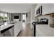 Modern kitchen with stainless appliances, gas range, and island that opens to the living area at 3794 Cantebury Dr, Franklin, IN 46131
