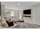 Upstairs living room provides a cozy retreat with a TV, comfortable couch, and neutral design at 3794 Cantebury Dr, Franklin, IN 46131