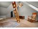 Attic area with decorative wooden ladder, sitting chair, ceiling fan, and neutral carpet at 4013 Hillendale Dr, Greenwood, IN 46142