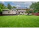Expansive backyard featuring a well-maintained lawn, storage shed, and deck, perfect for outdoor enjoyment and entertaining at 4013 Hillendale Dr, Greenwood, IN 46142