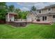 Expansive backyard with a deck, hot tub, gazebo, and a well-maintained lawn at 4013 Hillendale Dr, Greenwood, IN 46142
