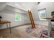 Charming bedroom featuring a ladder leading to a loft, skylights, and a unique colorful rug at 4013 Hillendale Dr, Greenwood, IN 46142