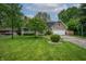 Charming home boasts a well-manicured lawn, inviting porch, and an attached two-car garage at 4013 Hillendale Dr, Greenwood, IN 46142