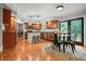 Bright, eat-in kitchen featuring stainless appliances, warm cabinetry, and hardwood floors at 4013 Hillendale Dr, Greenwood, IN 46142