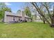 Expansive backyard featuring mature trees, a hot tub, and outdoor cooking space, perfect for entertaining at 4016 Dogwood Ln, Franklin, IN 46131