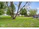 Large backyard with mature trees, a grassy lawn, and outdoor cooking equipment, offering a private outdoor space at 4016 Dogwood Ln, Franklin, IN 46131