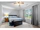 Comfortable bedroom with ceiling fan, large window with curtains, and neutral walls at 4016 Dogwood Ln, Franklin, IN 46131