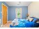 Serene bedroom with blue walls, plush bedding, and natural light from the window at 4016 Dogwood Ln, Franklin, IN 46131