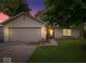 Charming single-story home with a brick facade, attached garage, and a well-maintained front yard at dusk at 4016 Dogwood Ln, Franklin, IN 46131