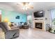 Comfortable living room featuring a fireplace, ceiling fan, and ample natural light at 4016 Dogwood Ln, Franklin, IN 46131