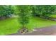 Spacious backyard with mature trees providing ample shade and privacy at 426 Tipton Ln, Columbus, IN 47201