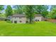 Expansive backyard featuring a well-manicured lawn, small deck, and mature trees at 426 Tipton Ln, Columbus, IN 47201