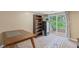Finished basement with sliding doors to the back yard, a bookshelf, carpet, and a small table at 426 Tipton Ln, Columbus, IN 47201