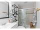 Updated bathroom with glass-enclosed shower, modern vanity, and stylish storage solutions at 426 Tipton Ln, Columbus, IN 47201