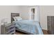 Serene bedroom featuring a bed with a quilted coverlet, natural light, and a calming, neutral color palette at 426 Tipton Ln, Columbus, IN 47201
