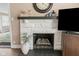 Elegant white brick fireplace with a dark mantel and decorative accents at 426 Tipton Ln, Columbus, IN 47201