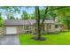 Charming one-story home with stone accents, attached garage, and well-maintained front yard at 426 Tipton Ln, Columbus, IN 47201