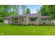 Attractive single-story home with stone facade, lush lawn, and mature landscaping at 426 Tipton Ln, Columbus, IN 47201