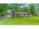 Charming single-story home with stone accents, attached garage, mature trees, and a well-maintained lawn at 426 Tipton Ln, Columbus, IN 47201