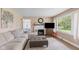 Bright living room featuring a fireplace, large sectional sofa, and natural light at 426 Tipton Ln, Columbus, IN 47201