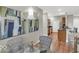 Modern kitchen featuring hardwood floors, stainless steel appliances, and bar seating at 435 Virginia Ave # 108, Indianapolis, IN 46203
