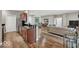 Open-concept kitchen and living room featuring granite countertops, stainless steel appliances, and hardwood floors at 435 Virginia Ave # 108, Indianapolis, IN 46203