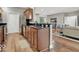 View of a kitchen and living room with stainless steel appliances, hardwood floors, and an open layout at 435 Virginia Ave # 108, Indianapolis, IN 46203