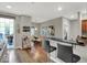 Contemporary living room and kitchen with hardwood floors, bar seating, and sliding door to balcony at 435 Virginia Ave # 108, Indianapolis, IN 46203