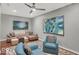 Open-concept living room featuring stylish seating, ceiling fan, and abstract artwork at 435 Virginia Ave # 108, Indianapolis, IN 46203