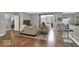 Stylish condo living area with hardwood floors, bar seating, and natural light at 435 Virginia Ave # 108, Indianapolis, IN 46203