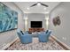 Well-lit living room featuring ceiling fan, accent lighting, and media center at 435 Virginia Ave # 108, Indianapolis, IN 46203