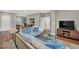 Spacious condo living room featuring modern decor, TV, and hardwood floors at 435 Virginia Ave # 108, Indianapolis, IN 46203