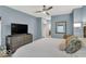 Tranquil bedroom features plush bedding, a ceiling fan, and a view to the ensuite at 435 Virginia Ave # 108, Indianapolis, IN 46203