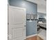 Bedroom doorway showcasing hardwood floors, light blue walls, and stylish decor at 435 Virginia Ave # 108, Indianapolis, IN 46203