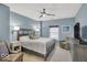 Serene main bedroom features a ceiling fan, plush bedding, and calming blue walls at 435 Virginia Ave # 108, Indianapolis, IN 46203