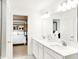 Bright bathroom featuring double sinks, large mirrors, and a view to the main bedroom at 4397 Persian St, Greenwood, IN 46143