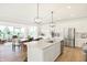Bright, open-concept kitchen with a large island, stainless steel appliances, and modern light fixtures at 4397 Persian St, Greenwood, IN 46143