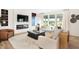 Bright living room with large windows, a modern fireplace, light hardwood floors, and neutral-toned furniture at 4397 Persian St, Greenwood, IN 46143
