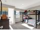 Charming bunk bedroom with a wooden bunk bed, blue accents, and plenty of natural light at 4437 Persian St, Greenwood, IN 46143