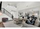 Open concept living room flowing into kitchen with staircase and gray contemporary decor at 4437 Persian St, Greenwood, IN 46143