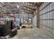 View of barn interior with overhead door and storage at 4605 S 150 W, Columbus, IN 47201