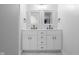 A modern bathroom features a double sink vanity, white cabinets, and black hardware at 4605 S 150 W, Columbus, IN 47201
