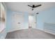 Serene bedroom features blue walls, carpet, closet, and a ceiling fan at 4605 S 150 W, Columbus, IN 47201