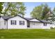 Charming single-story home with a sprawling front lawn, a covered porch and a American flag at 4605 S 150 W, Columbus, IN 47201