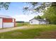 Exterior view of the house with a red and white barn in the background at 4605 S 150 W, Columbus, IN 47201